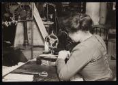 [Woman at sewing machine]