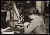 [Woman at sewing machine]
