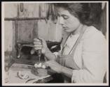 Making artifical roses, young Italian girl