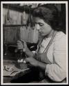 [Young Italian girl making artifical roses]