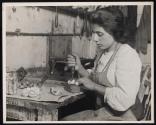 [Young Italian girl making artifical roses]