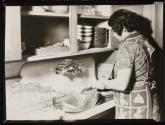 [Woman washing dishes]