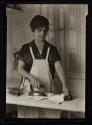 [Housewife ironing with electric iron]