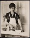 [Housewife ironing with electric iron]