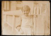 [Small girl by picket fence]