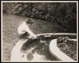 [Boy playing with toy boats]