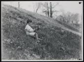[Small child playing in field]
