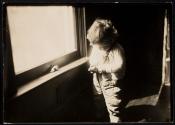 [Small child by window]