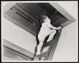 [Child climbing ladder to attic]