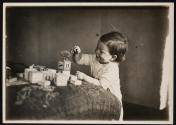 [Child playing with toys and blocks]