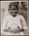 [Black girl holding melon]