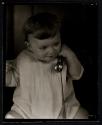 [Portrait of child with toy telephone]