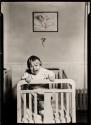 [Baby standing in crib]