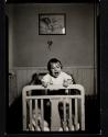 [Baby standing in crib]