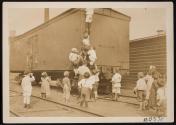 [Children climbing on boxcar]