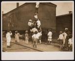 [Children climbing on boxcar]