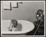 [Young girl in bathtub]