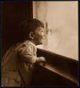 [Child by window]