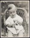 [Young child with flower]