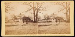 [Soldiers standing in yard beside house]