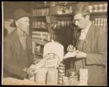 [Man & clerk in general store]