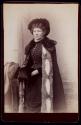 [Woman wearing fur coat and accessories]