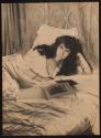 [Olga De Meyer, lounging in bed]