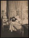 [Olga De Meyer, lounging in bed]