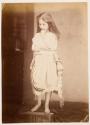 [Pensive young girl, posing on a box]