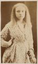 [Young girl holding a jug]