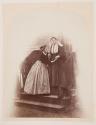[Young woman with blind old woman]