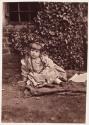 [Young girl with ivy wall in the background]