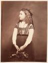 [Girl holding basket]