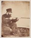 [Man aiming rifle]