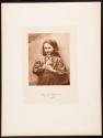 [Young girl holding mirror]