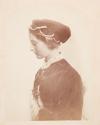 [Portrait of woman in profile, wearing hat with pearls]