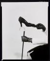 [Vogue fashion photograph - shoe / black gloved hand / cane]