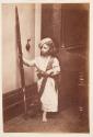 [Child posing with rifle]