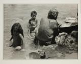[Woman and children by riverbank]