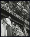 [People gathered to watch a street event]