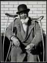 [Black man with crutches]