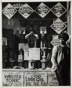 [Young man in front of drugstore]