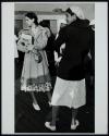 [Two women in white shoes]