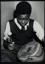 [Boy playing a drum]
