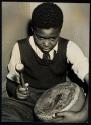 [Boy playing a drum]