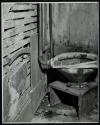 [Toilet on wooden stand]