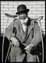 [Black man with crutches]