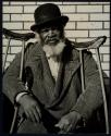 [Black man with crutches]