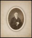 [Middle-aged man, seated with cane]