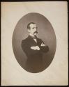 [Young man with dark hair and moustache, standing with arms folded (3/4 length)]